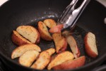 Red Wedge Potatoes Cooking in pan