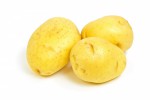 Raw Yukon Gold potatoes on white background horizontal format